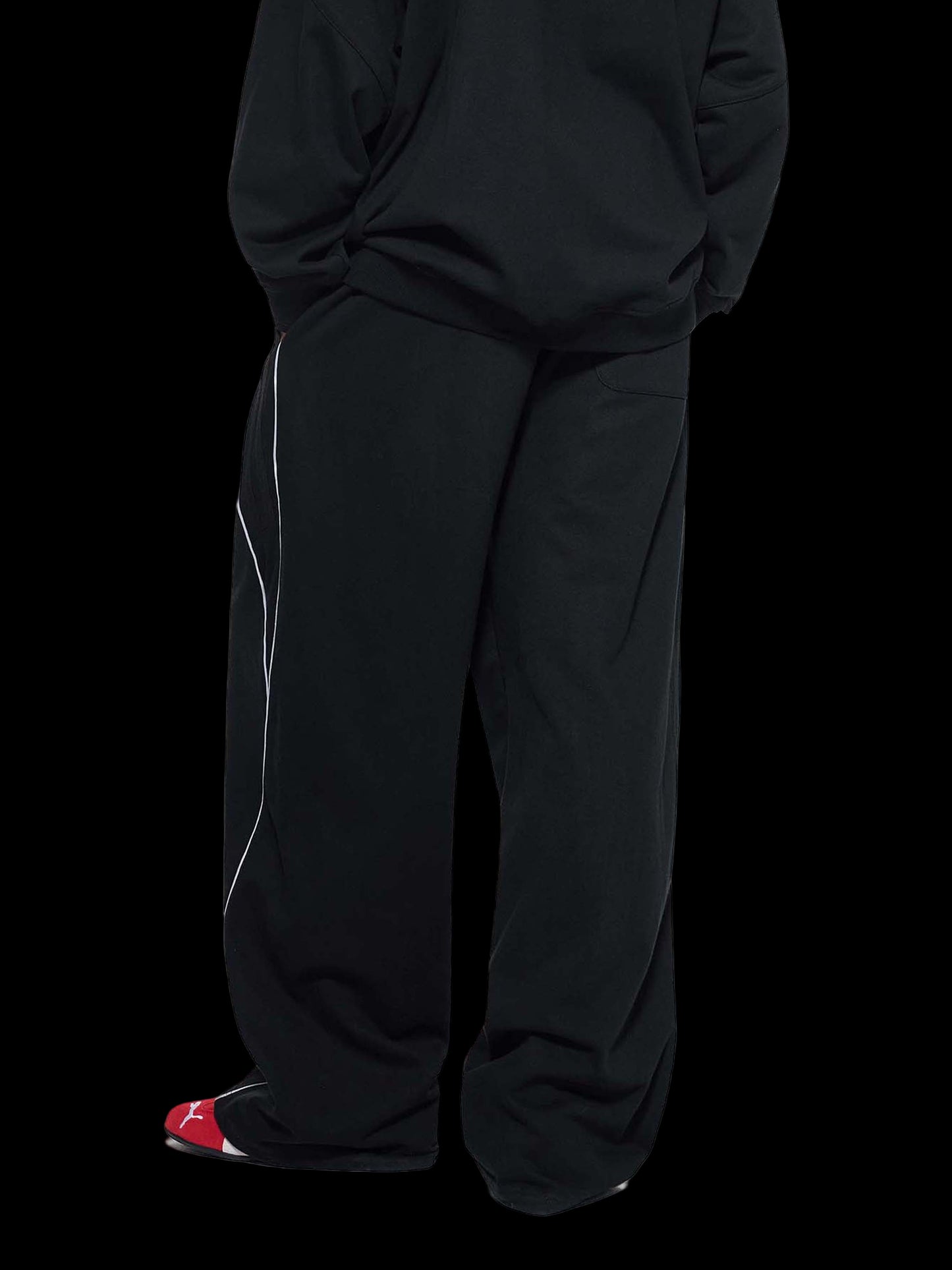 Person wearing black pants on a white background