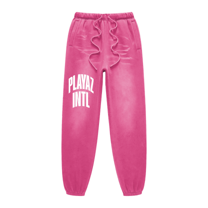 Pink sweatpants with 'PLAYAT INTL' text on a white background