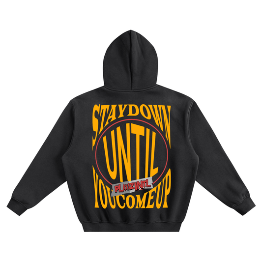 Black oversized streetwear hoodie with bold yellow Stay Down Until You Come Up PLAYAZ INTL graphic on the back