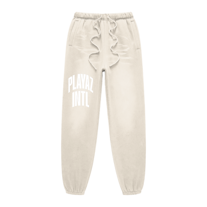 Beige sweatpants with ruffled waistband and text on a white background