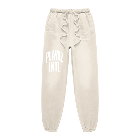 Beige sweatpants with ruffled waistband and text on a white background