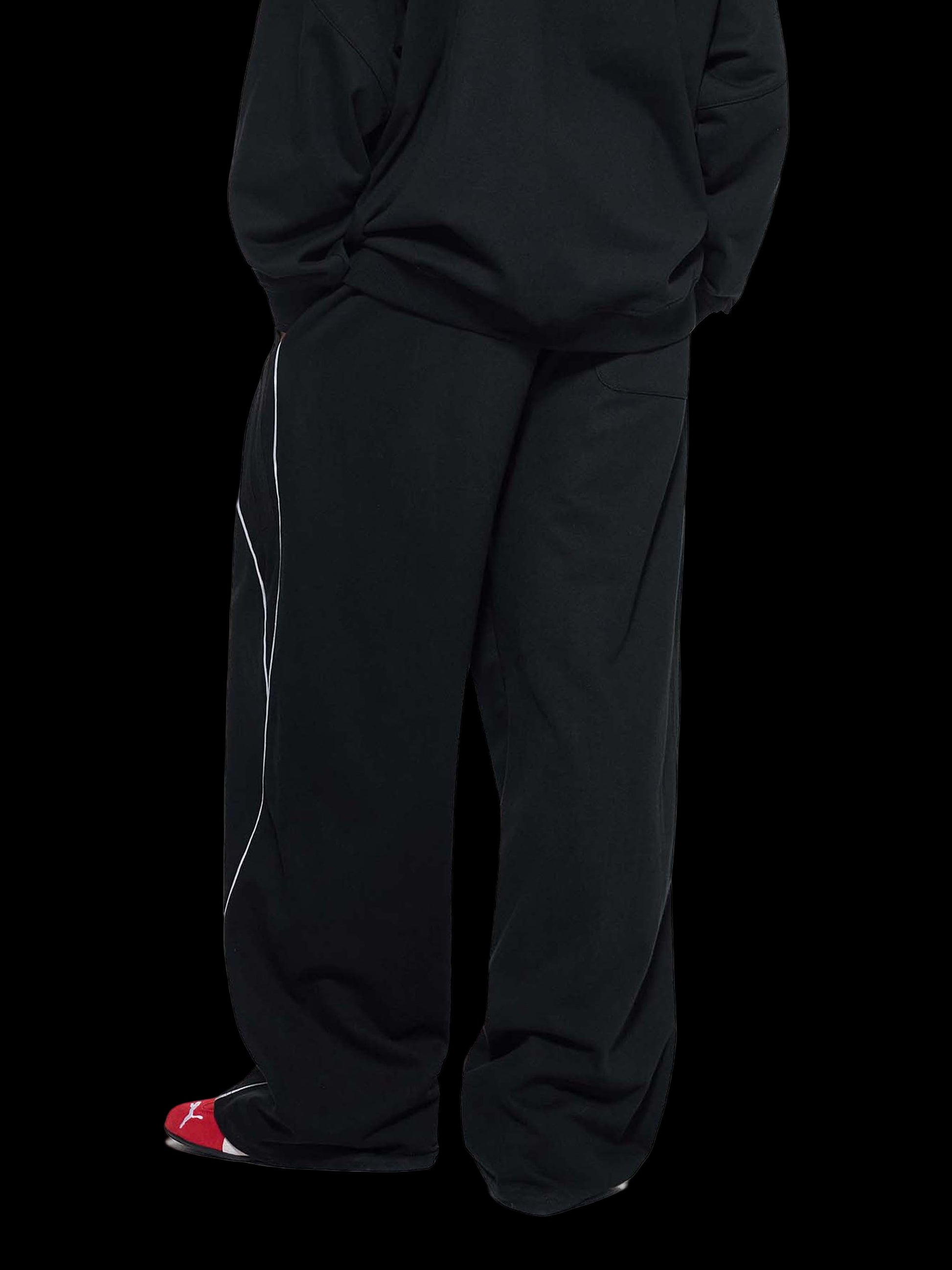 Person wearing black pants on a white background