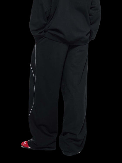 Person wearing black pants on a white background